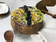 Afbeelding in Gallery-weergave laden, Sfeerbeeld van de Coconut Bowl Papu Palm robuust met erin chocolade smoothie met kiwi, sinaasappel en blauwe bessen